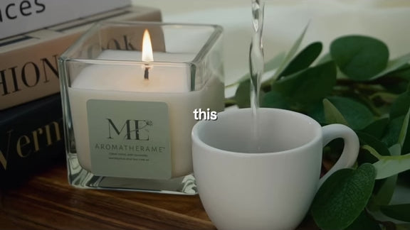 Load video: This video describes Aromatherame candles being used in a lifestyle setting, pouring a cup of water to relax.